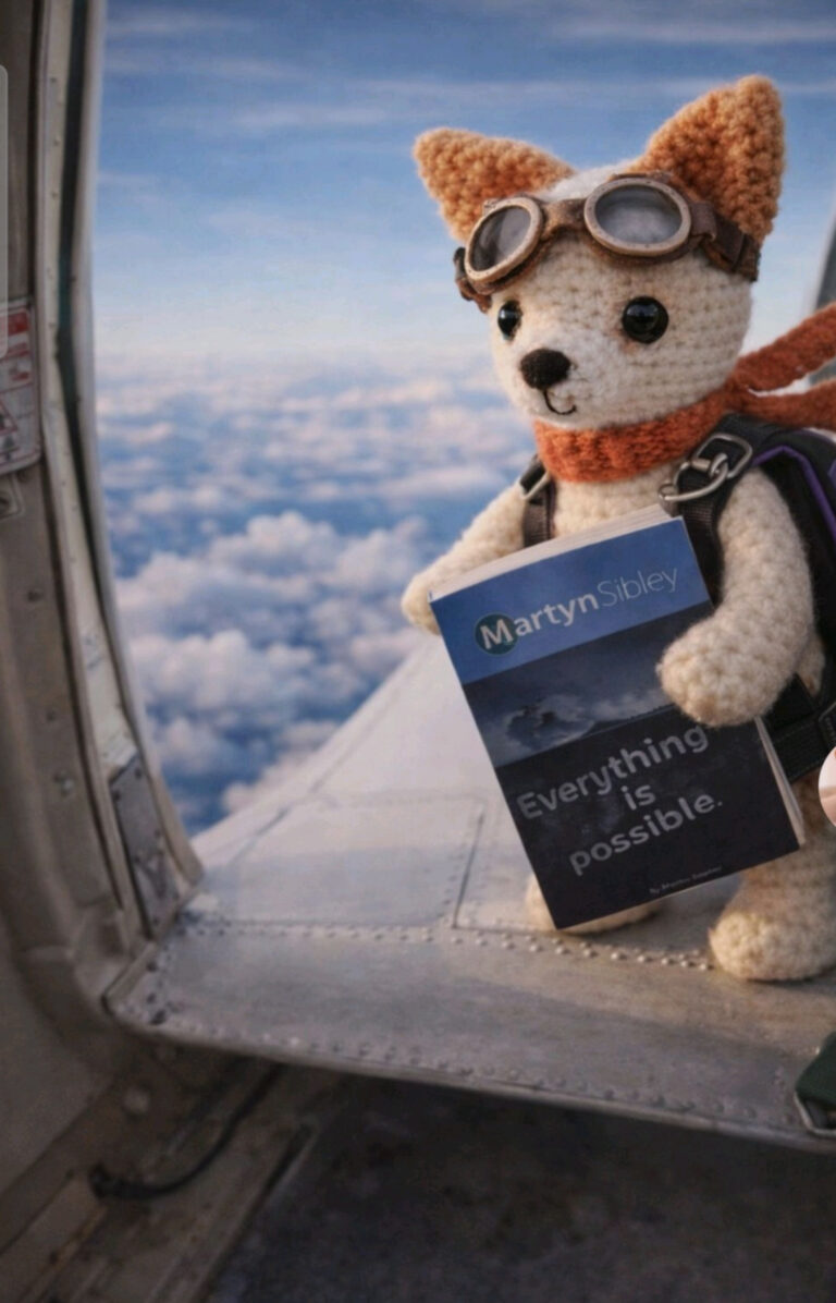 A small knitted dog mascot wearing aviator goggles and a scarf sits on the edge of an aeroplane door high above the clouds, holding the book Everything is Possible by Martyn Sibley, creating a playful, adventurous travel scene.