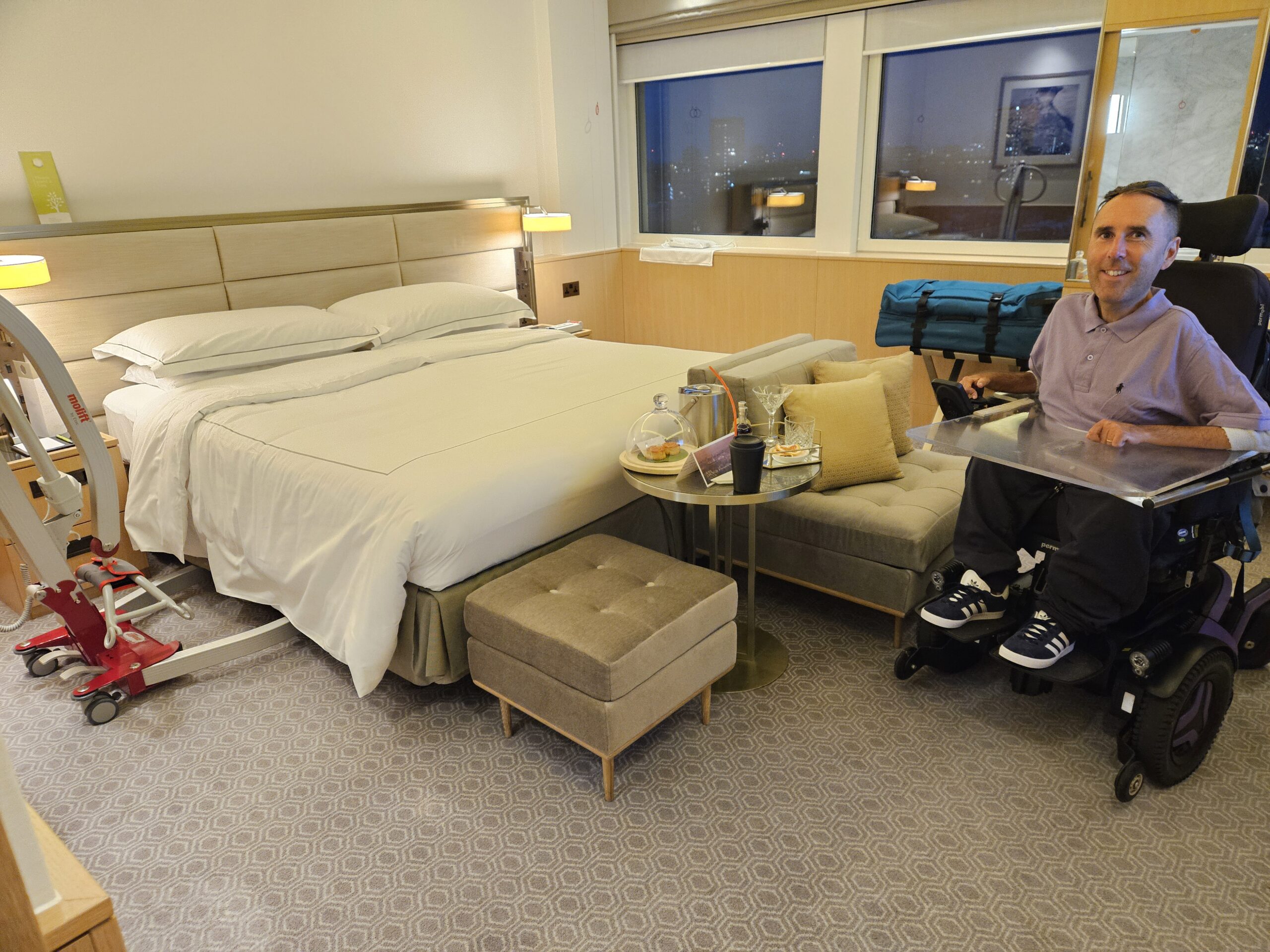 Photo of Martyn Sibley in a hotel room with a hoist