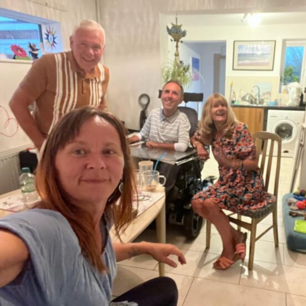 Martyn, Kasia, Martyn's mum and stepdad around a table at home